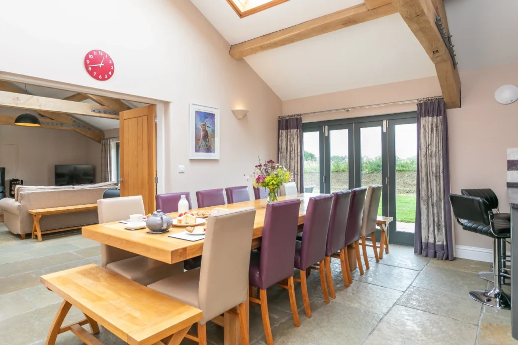 Brockram Barn dining table, extended to seat 16 (2 people on the bench at either ends of the table)